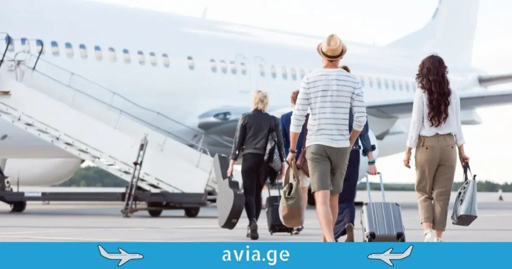 Passengers walking towards the airplane at the airport for boarding