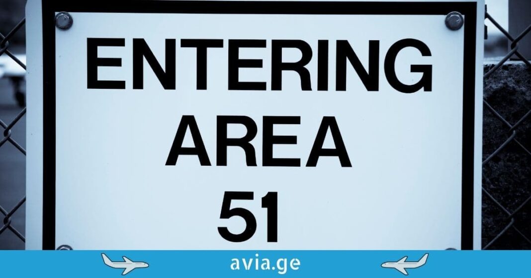 Restricted Area 51 Warning Sign. A restricted warning sign on a chain-link fence that reads "Entering Area 51."