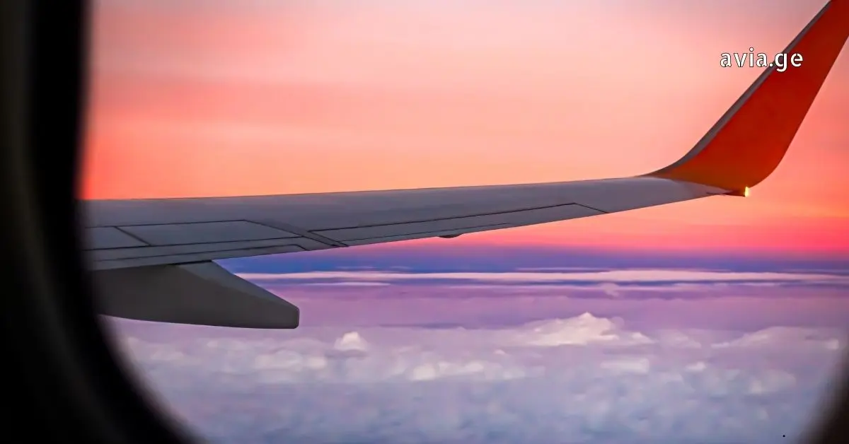 airliner flying in sky above clouds.