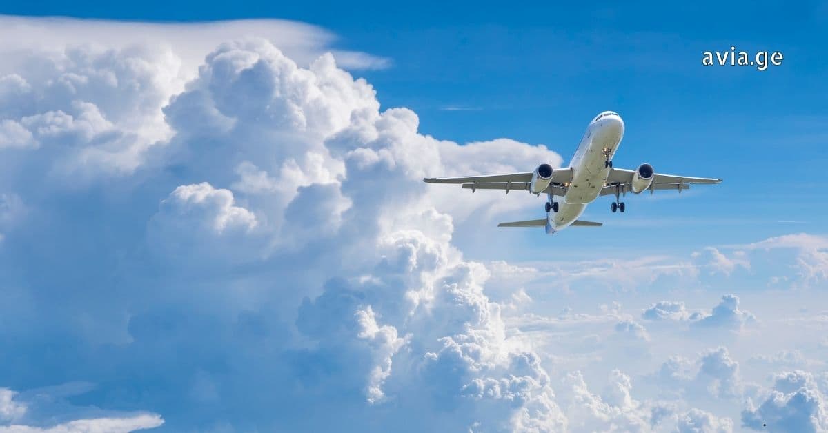 Passenger Aircraft Ascending Through Cumulus Clouds