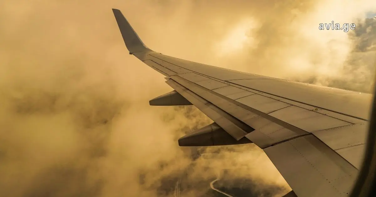 Airplane wing above clouds during flight