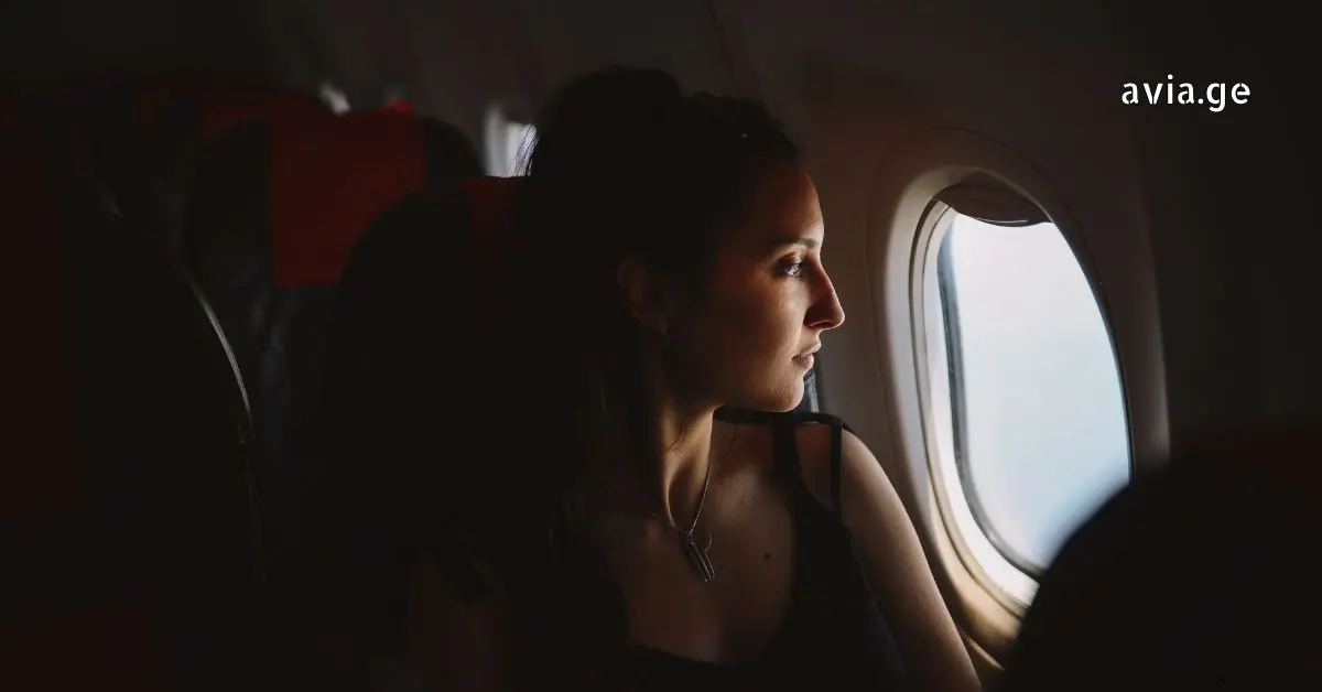 Woman looking out airplane window