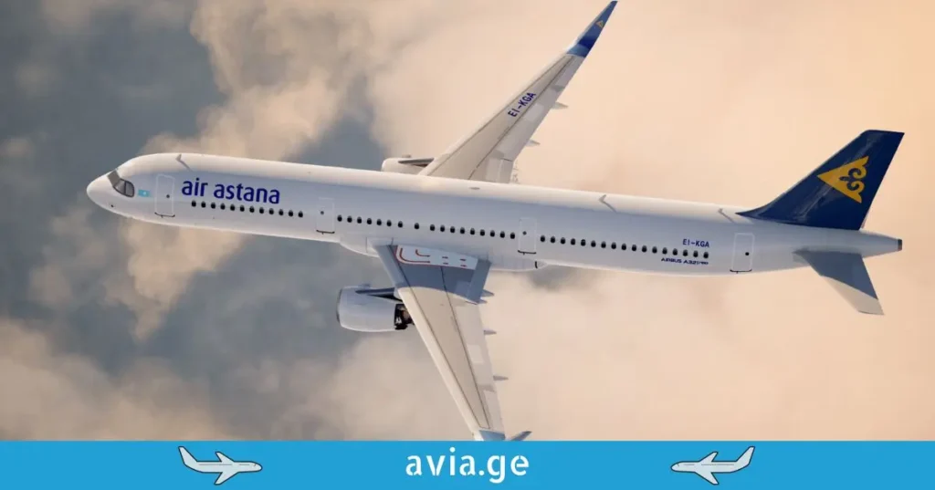Air Astana Airbus A321neo with registration EI-KGA flying above clouds.