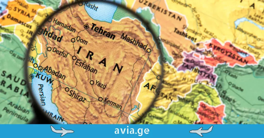 Magnifying glass focused on a map of Iran and surrounding Middle Eastern countries.