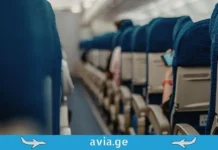 რატომ არ აქვს თვითმფრინავებს 13 ნომერი რიგი? ავიაკომპანიების უცნაური ცრურწმენები Perspective view of blue airplane seat rows in a cabin with avia.ge logo banner.