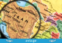 რატომ აუქმებენ ავიაკომპანიები რეისებს ახლო აღმოსავლეთში და რა ბედი ელის მოგზაურობას? Magnifying glass focused on a map of Iran and surrounding Middle Eastern countries.