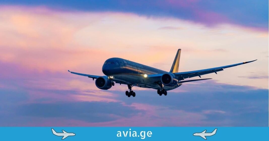 Commercial aircraft flight at twilight Airplane landing at sunset with a purple and pink sky background