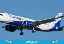 საქართველოს მიმართულებით შეჩერებული ფრენები – IndiGo: საჰაერო მიმოსვლა შეჩერებულია Close-up of an IndiGo Airlines plane taxiing at an airport, with another plane (Emirates) tail fin visible behind it.