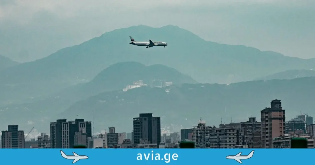 commercial-airplane-flying-over-city-and-mountains A single commercial airplane, labeled with 'aviation', flying at low altitude over a dense urban cityscape with mountains in the background.