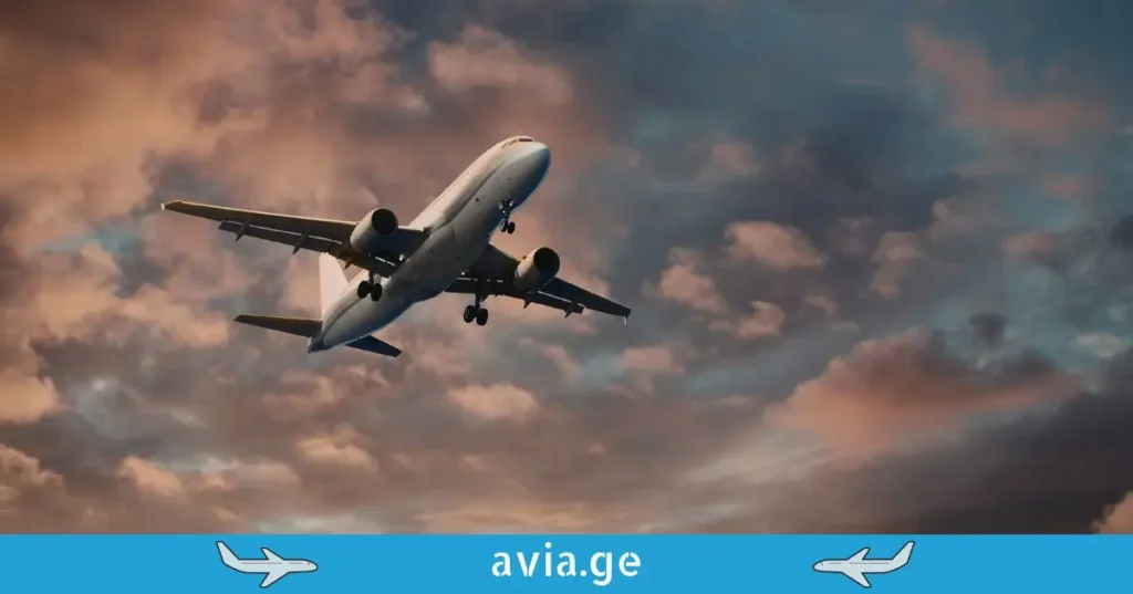 Passenger plane flying through sunset clouds