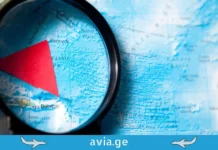 „ბერმუდის სამკუთხედი“ ცაში? რატომ არიდებენ თავს თვითმფრინავები წყნარი ოკეანის გარკვეულ მონაკვეთებს A magnifying glass focused on a red triangle marking the Bermuda Triangle on a world map.