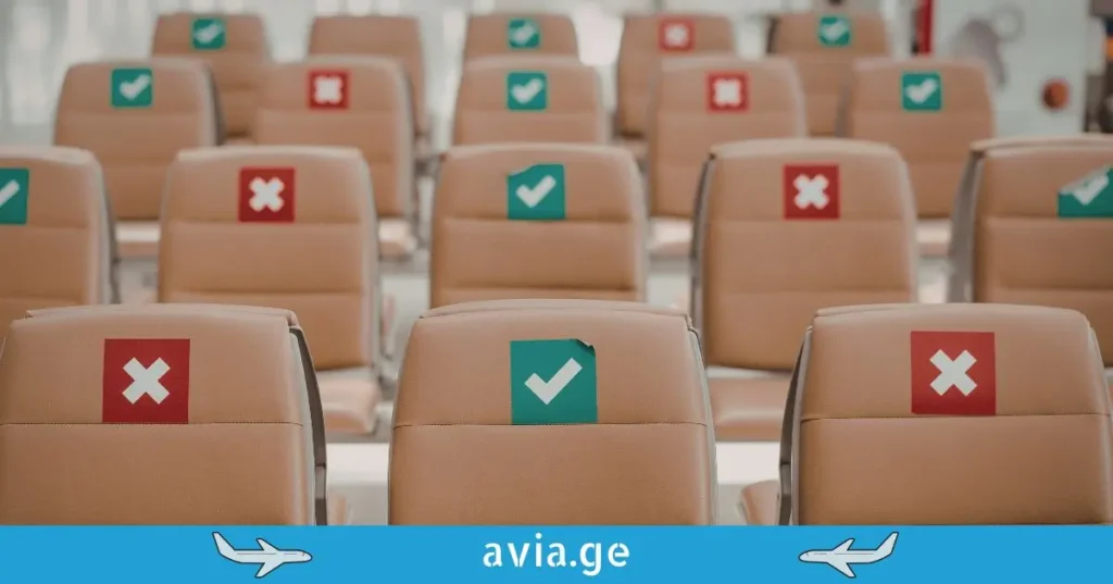 rows of tan airplane seats with red cross and green checkmark stickers
