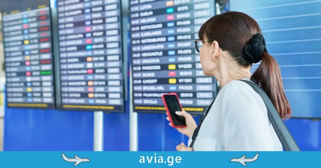 Passenger checking flight status at airport