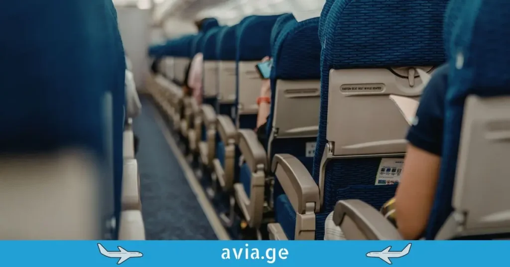 Airplane interior cabin with empty seats.